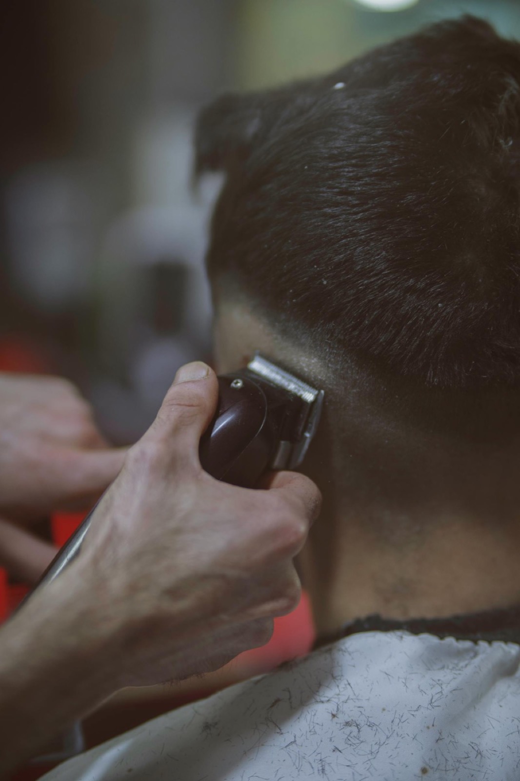 Barber clippers and tools on a tray