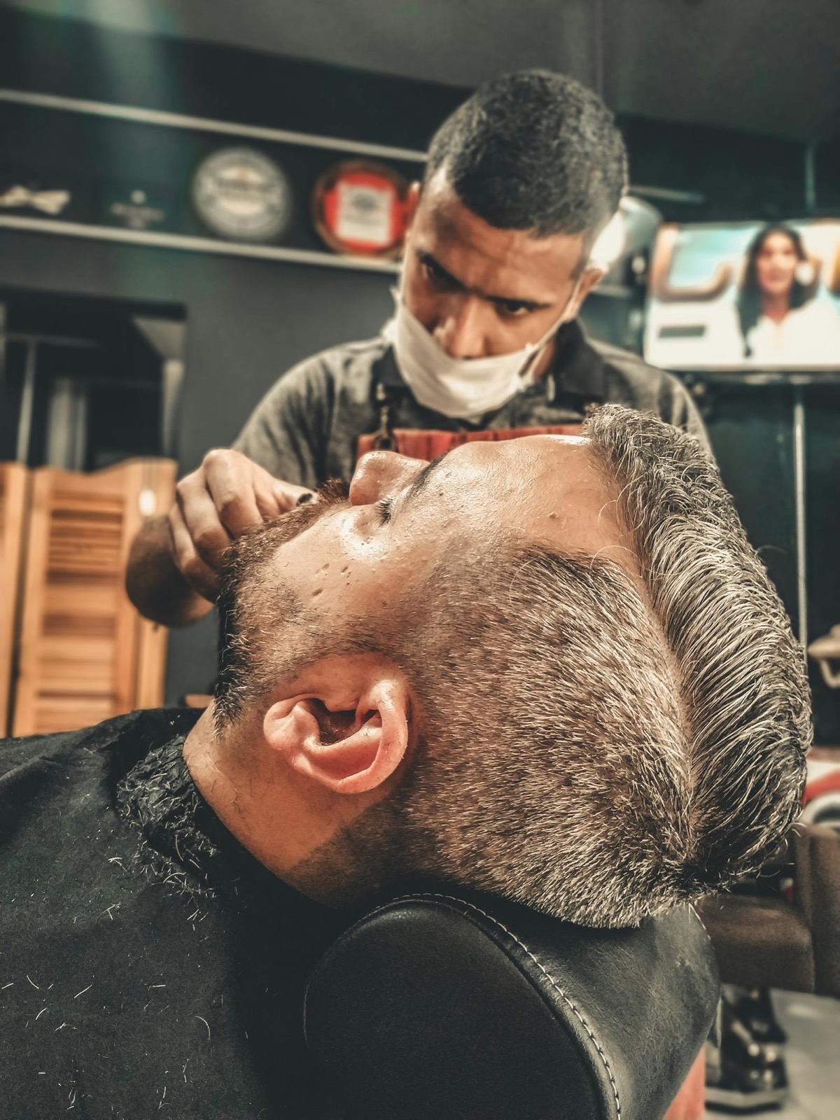 Apprentice barber working at a chair